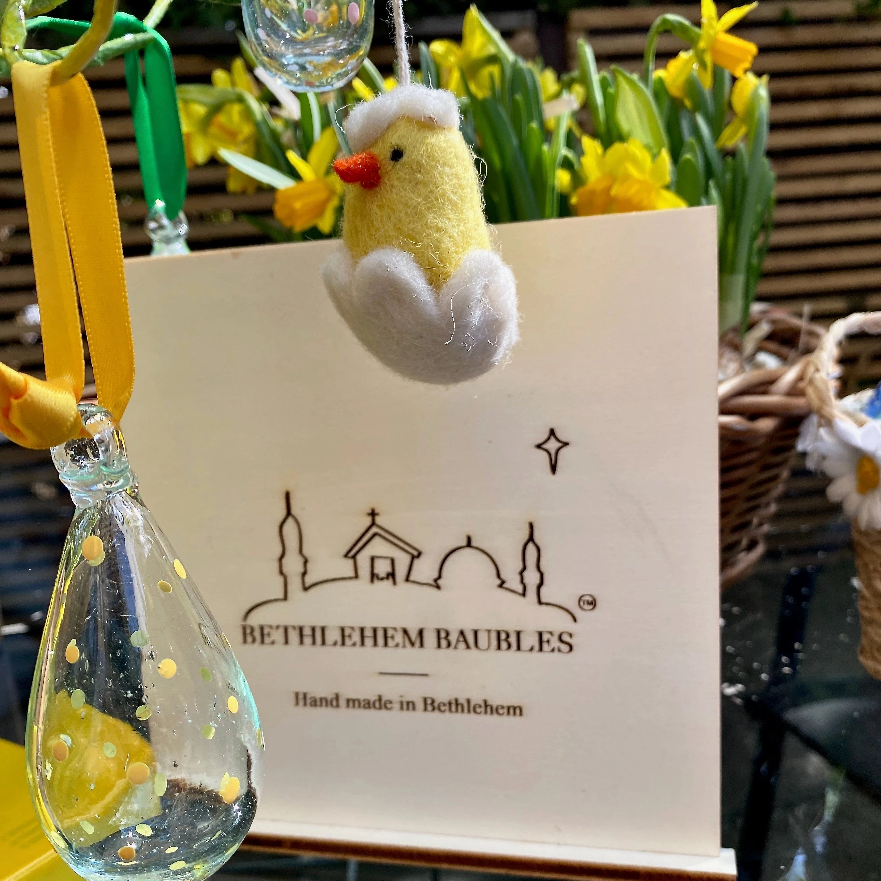 Mini glass baubles for an Easter tree in yellow, pink and green handprinted dots with colourful ribbons.