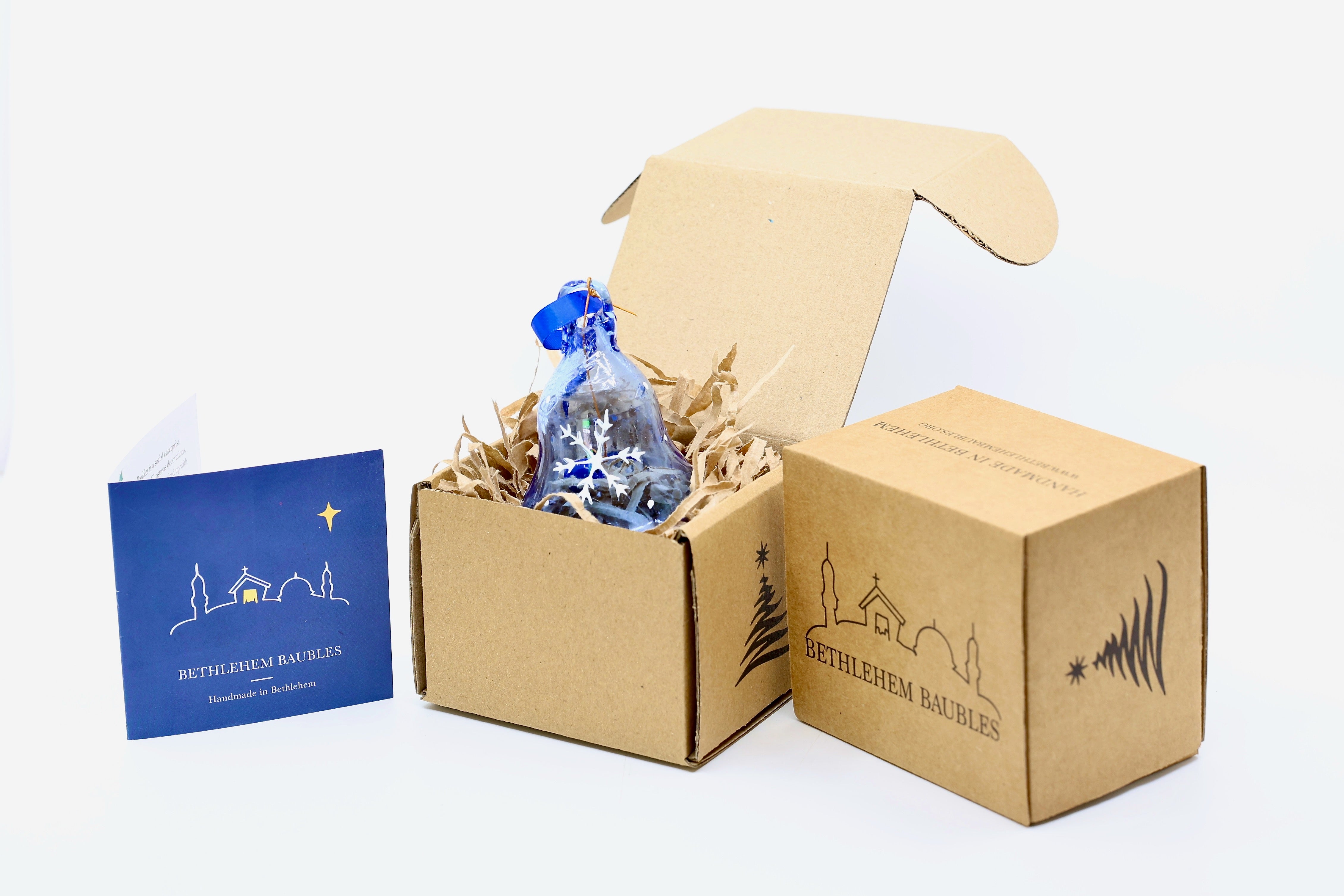 Blue bell Christmas decoration with glass dong in Hebron blue recycled glass. Painted with white snowflake hanging on blue ribbon.