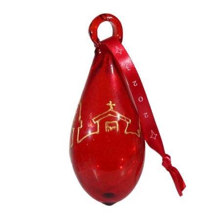 Close-up view of Red tear-shaped Christmas ornament with gold Bethlehem scene design
